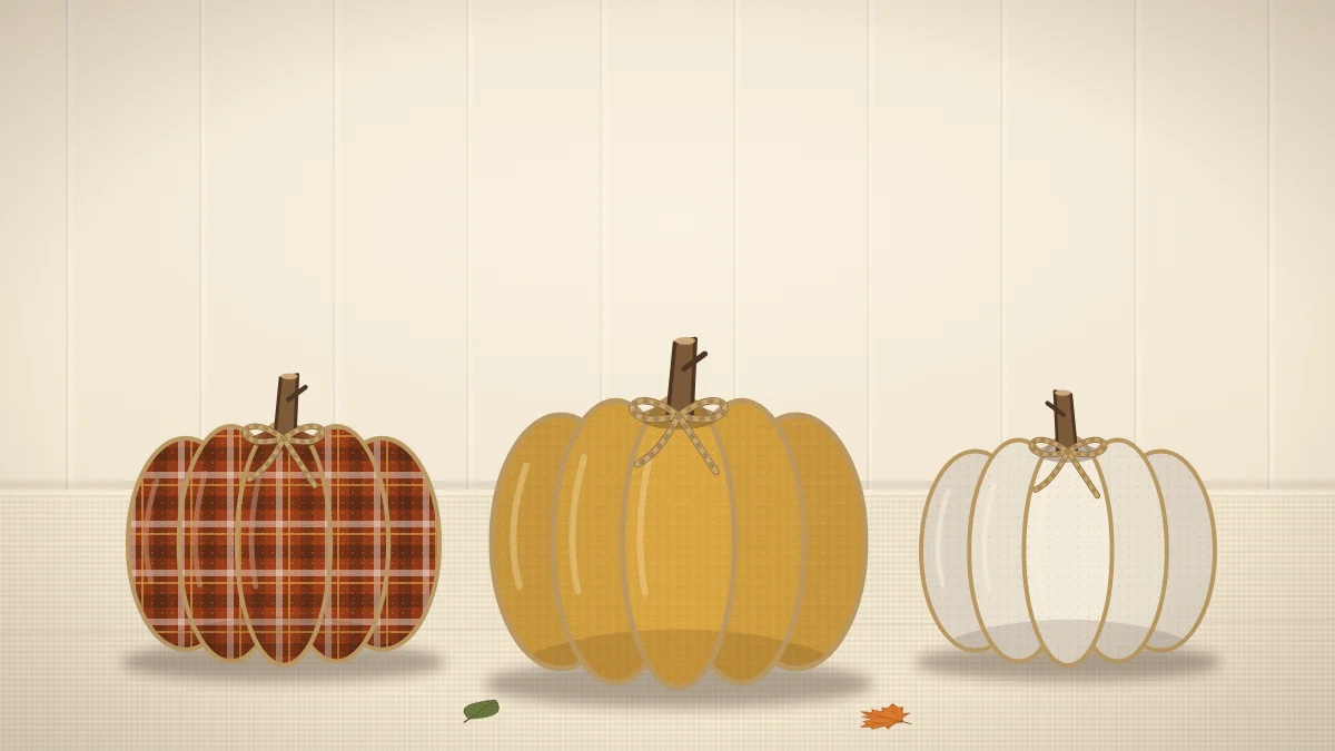 Three plump fabric pumpkins in plaid, mustard and cream with short stick stems and a twist of twine on each