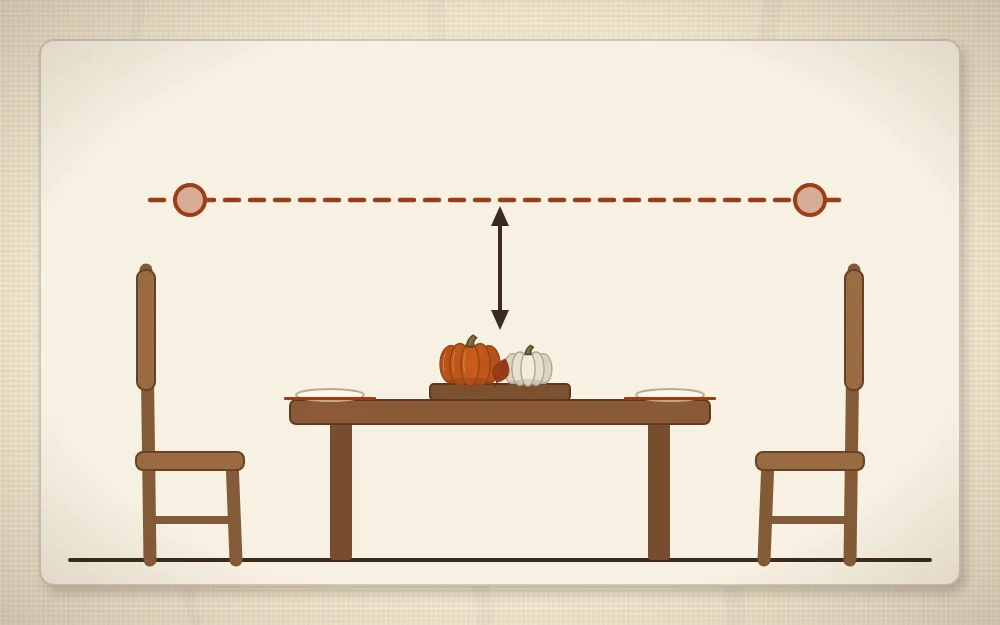A side view of a table with a low centerpiece and a dashed line showing it stays below the eye level of two place settings