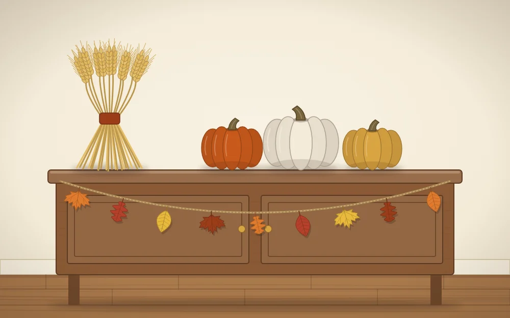 A sideboard with a wheat bundle, a row of three pumpkins and a short leaf garland along the front edge