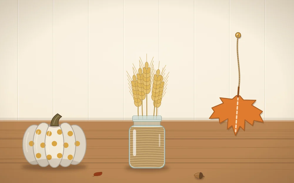 A painted mini pumpkin, a twine-wrapped jar holding wheat and a felt leaf on a string
