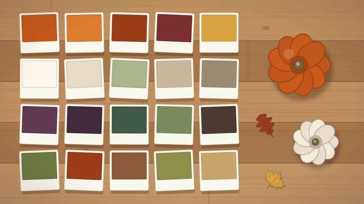 Four rows of five paint swatch cards in fall colors on a wooden table with two small pumpkins beside them