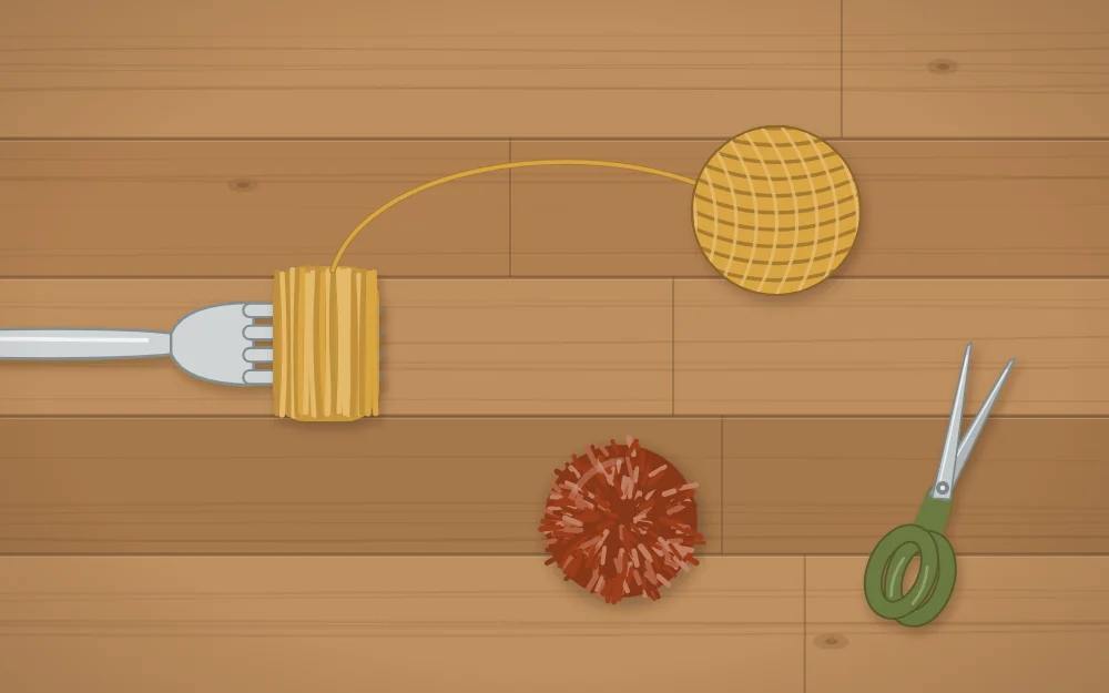 A yarn pom-pom being wrapped around the tines of a fork with scissors beside it
