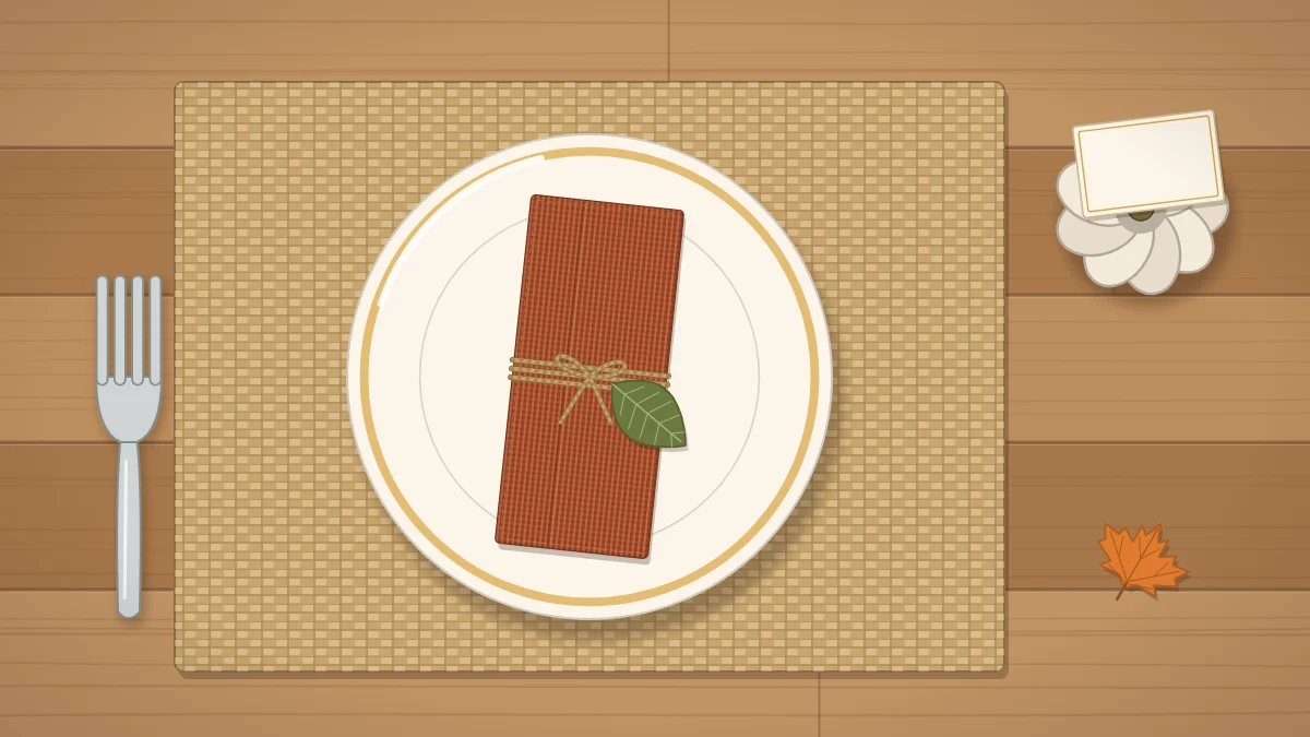 A fall place setting from above with a woven placemat, cream plate, rust napkin tied with twine and a mini pumpkin holding a blank card