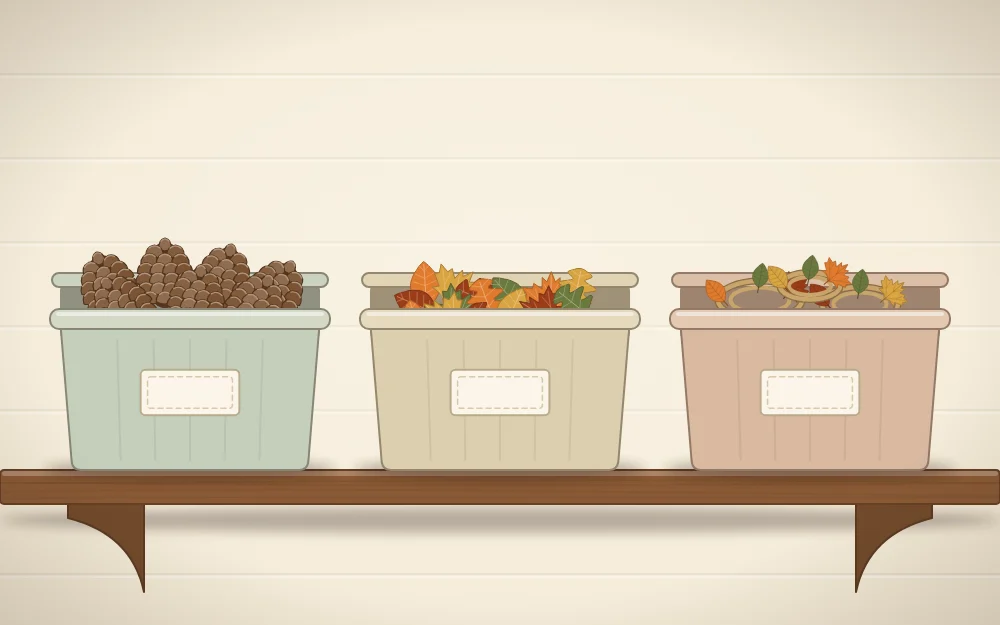 Three small bins with blank tags holding pinecones, felt leaves and coiled garlands