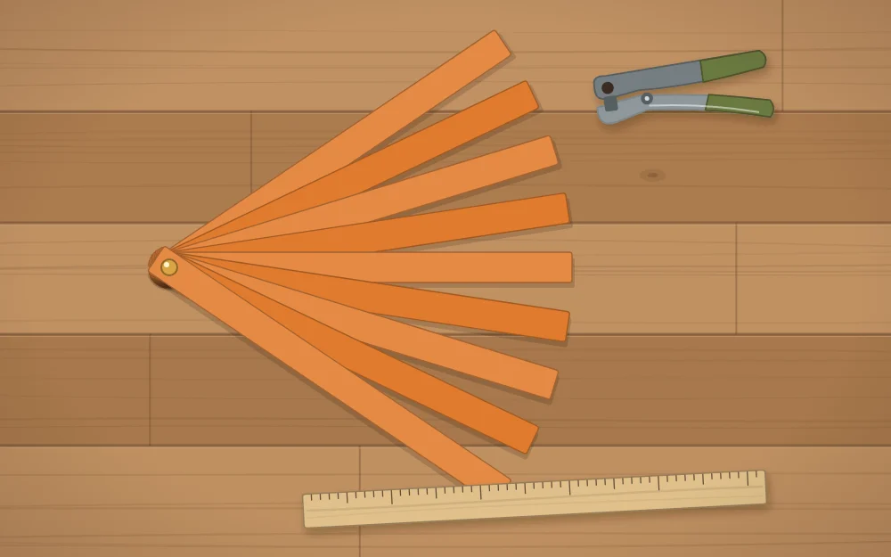 A fan of equal orange paper strips fastened together at one end, with a hole punch and a ruler beside them