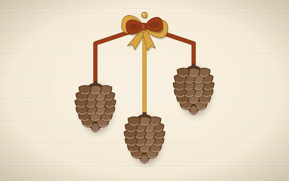 Three pinecones hanging at different heights from rust and mustard ribbons tied in a bow at the top