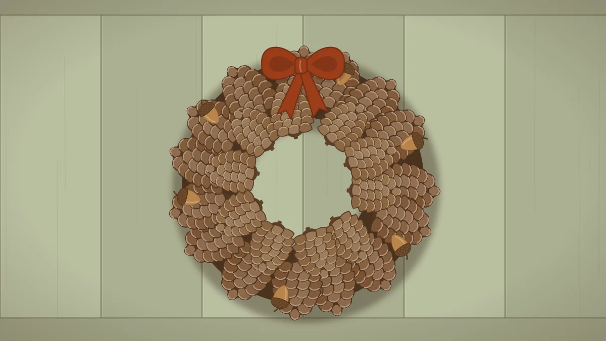 A dense wreath made of brown pinecones in two rings with a few acorns tucked in and a rust ribbon bow at the top