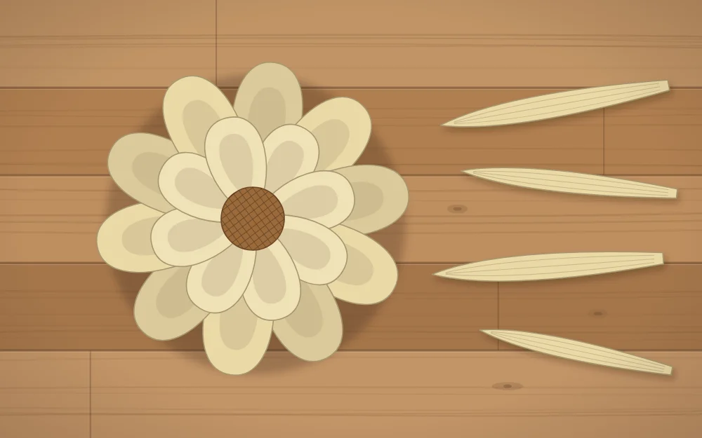 A flower made from overlapping pale corn husk loops with a round center, beside loose husk strips